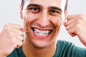 man flossing after learning what to know about braces
