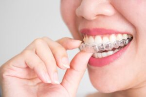 young woman learning that Invisalign® Can Improve Your Smile Discreetly