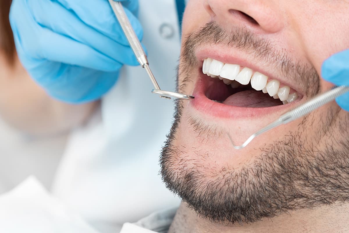 man gets an oral checkup to maintain oral health after thanksgiving