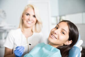 A hygienist and a dental patient receiving quality orthodontic care in John's Creek GA